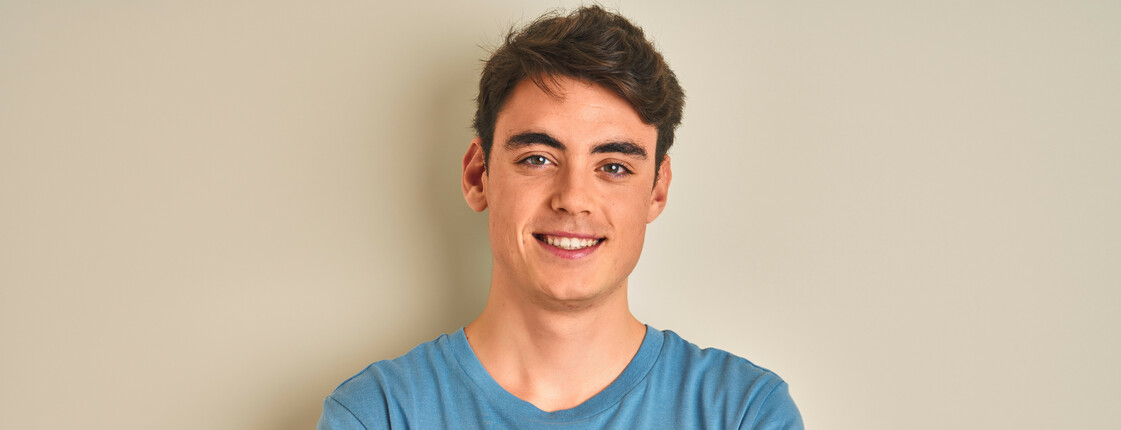 Teenager boy wearing casual t-shirt standing over isolated background happy face smiling with crossed arms looking at the camera. Positive person.