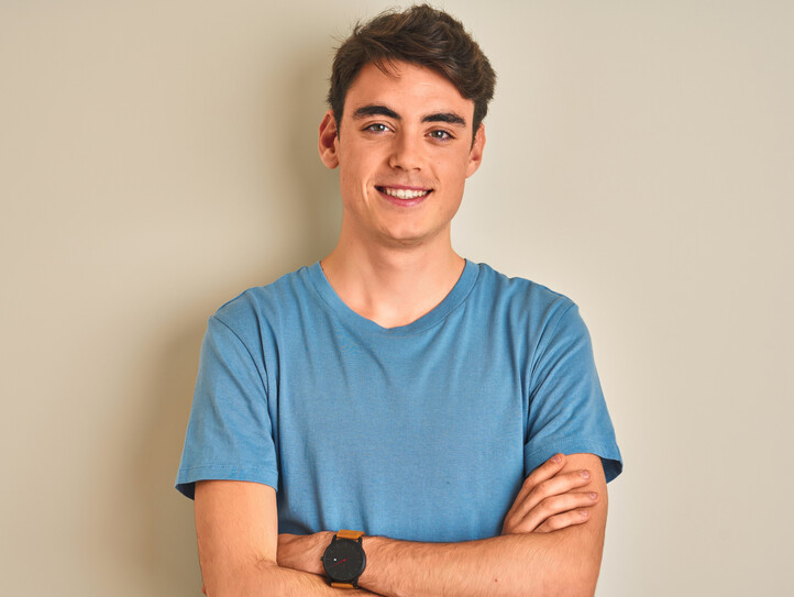 Teenager boy wearing casual t-shirt standing over isolated background happy face smiling with crossed arms looking at the camera. Positive person.